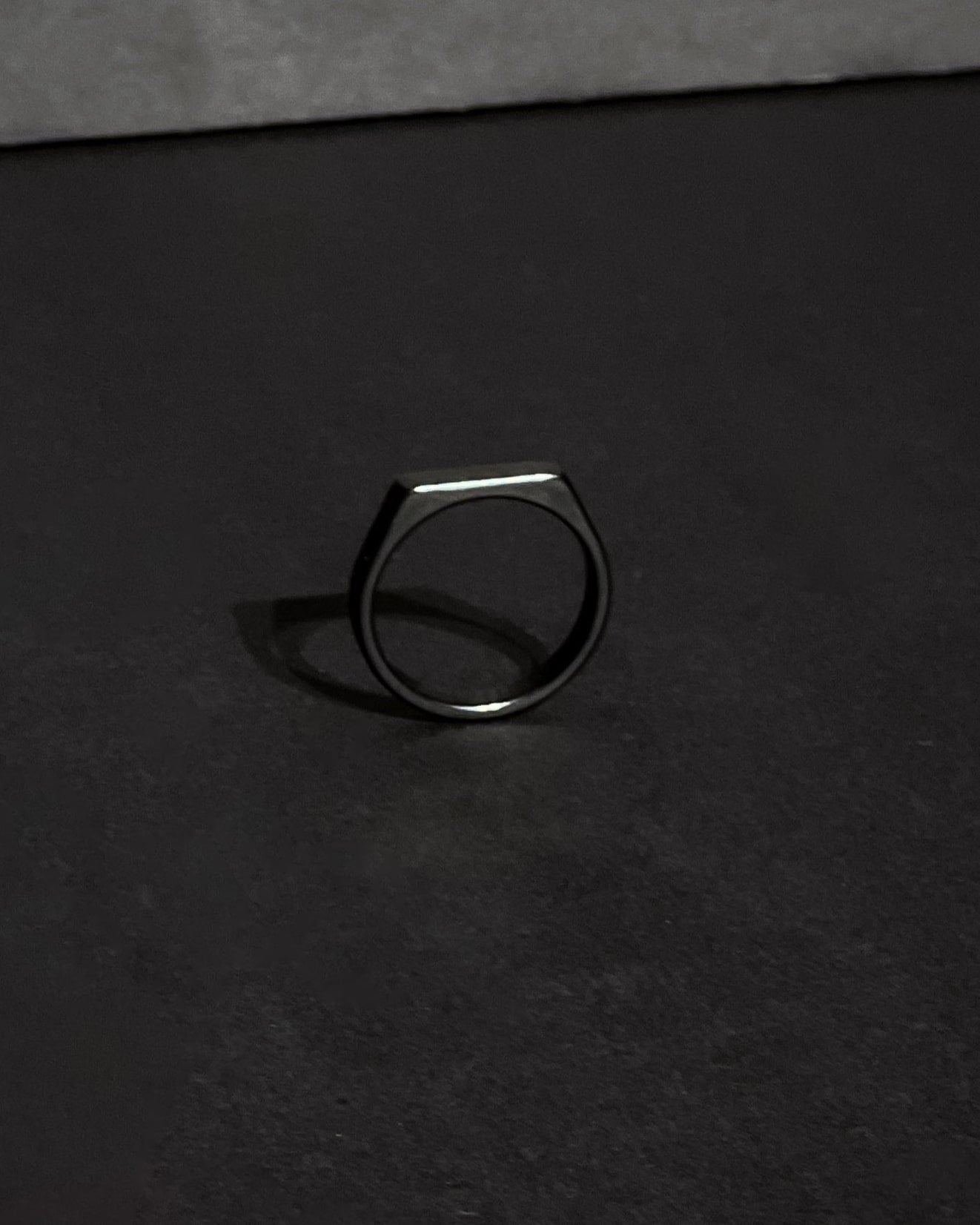 Silver ring on a black surface