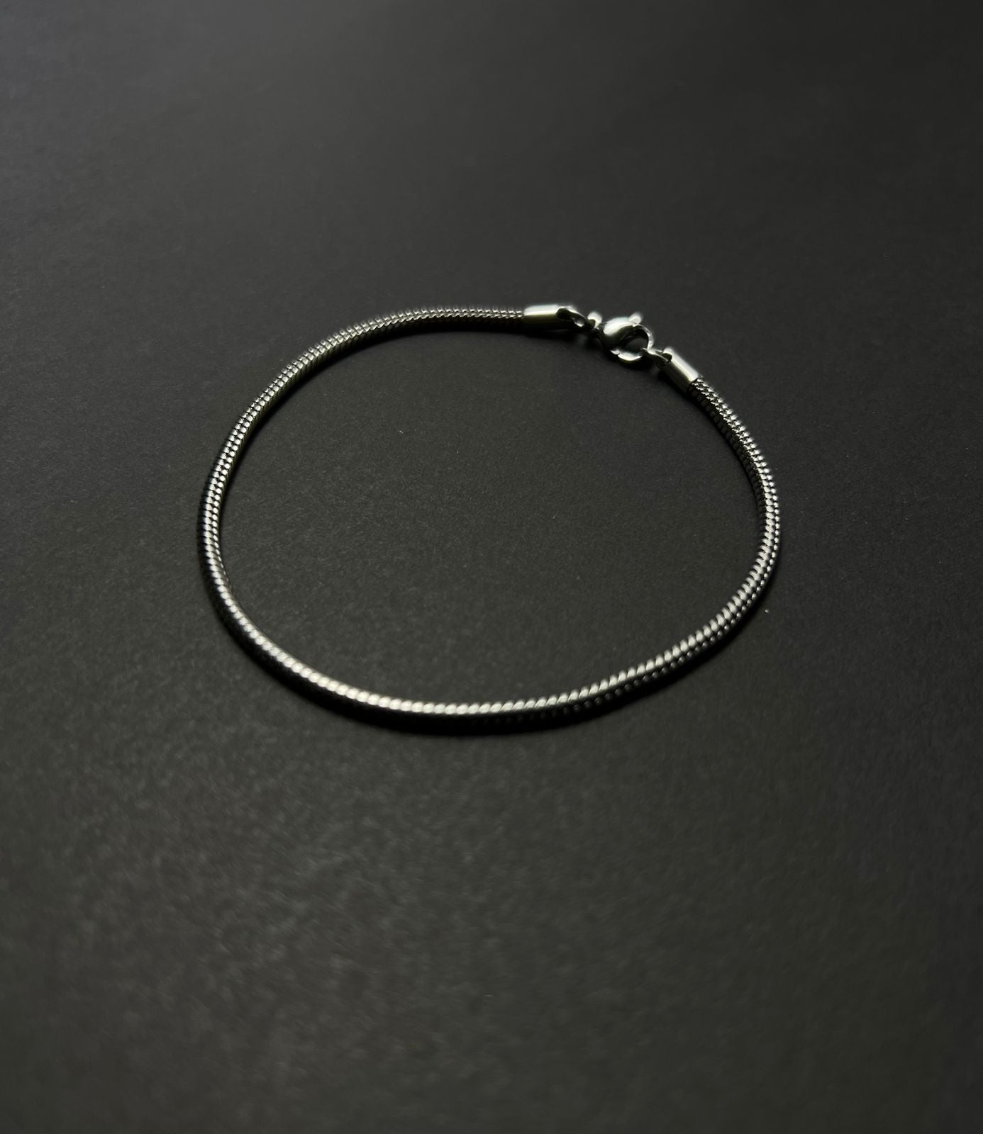Silver bracelet on a black background