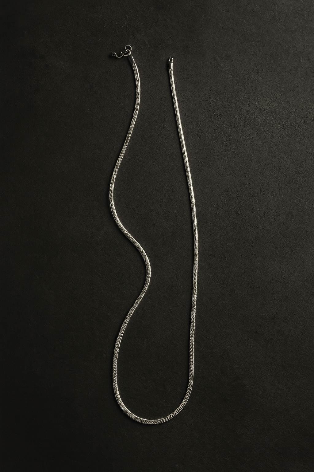 Silver necklace on a black background