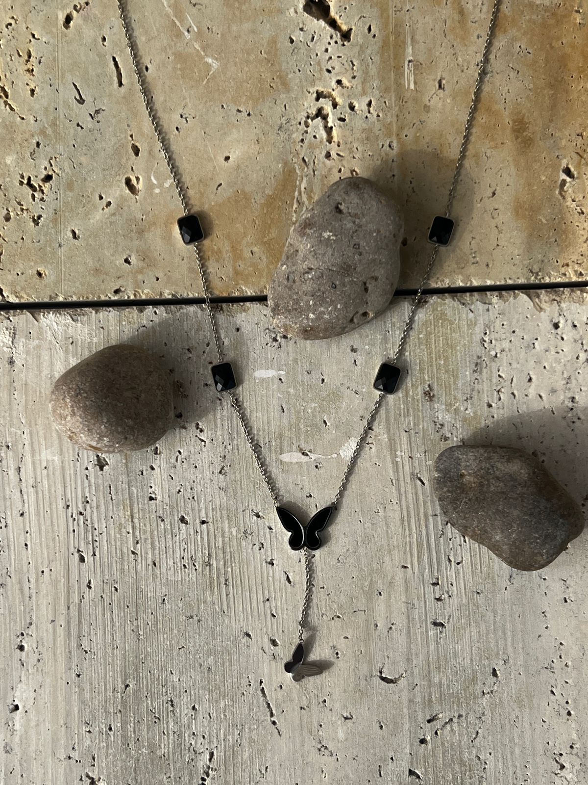 Butterfly pendant necklace with black charm accents — a piece of minimalist butterfly jewelry and nature-inspired design for everyday wear.