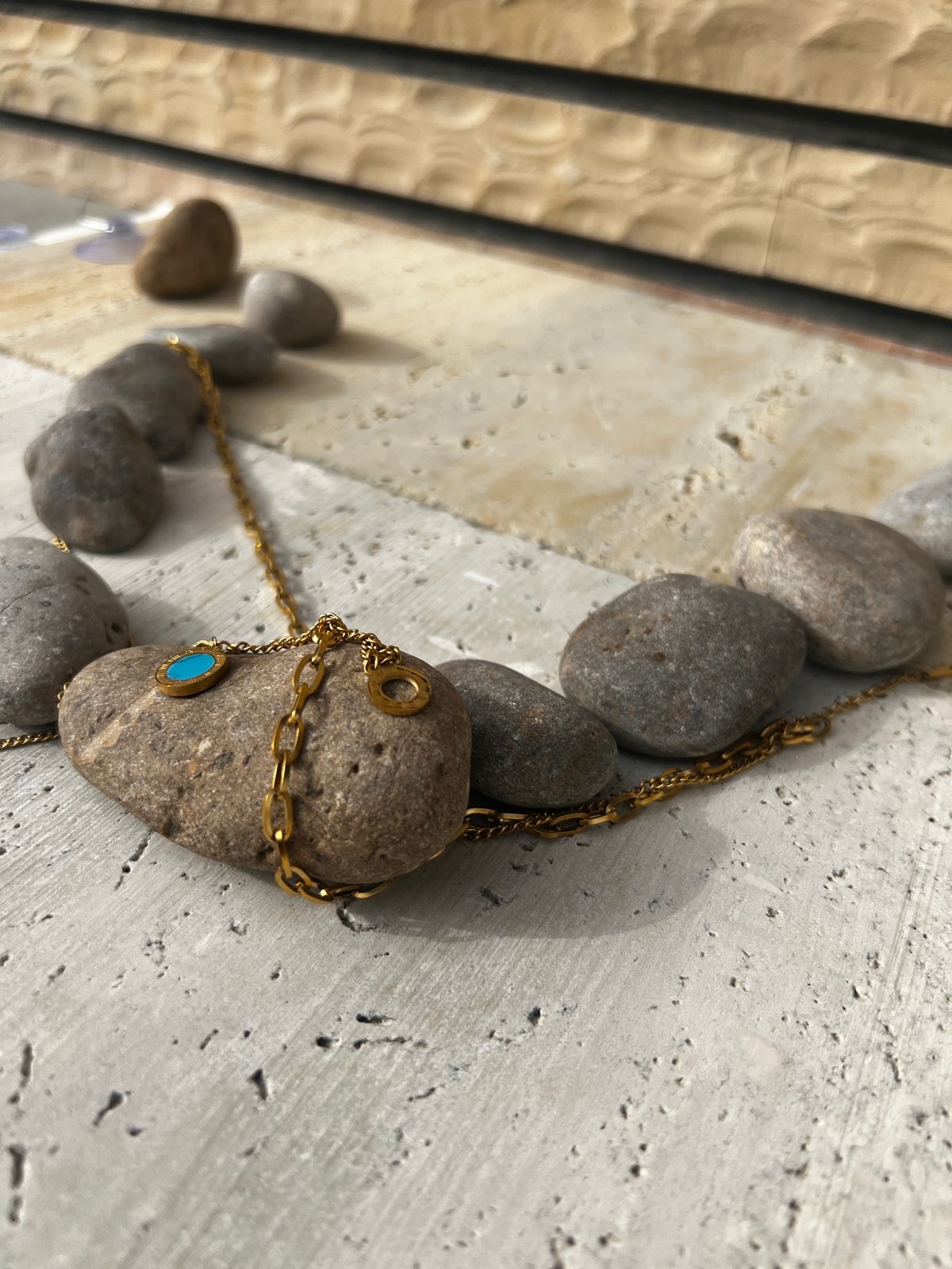 Layered gold necklace featuring a turquoise pendant — a piece of minimalist layered jewelry and an everyday statement necklace for women.