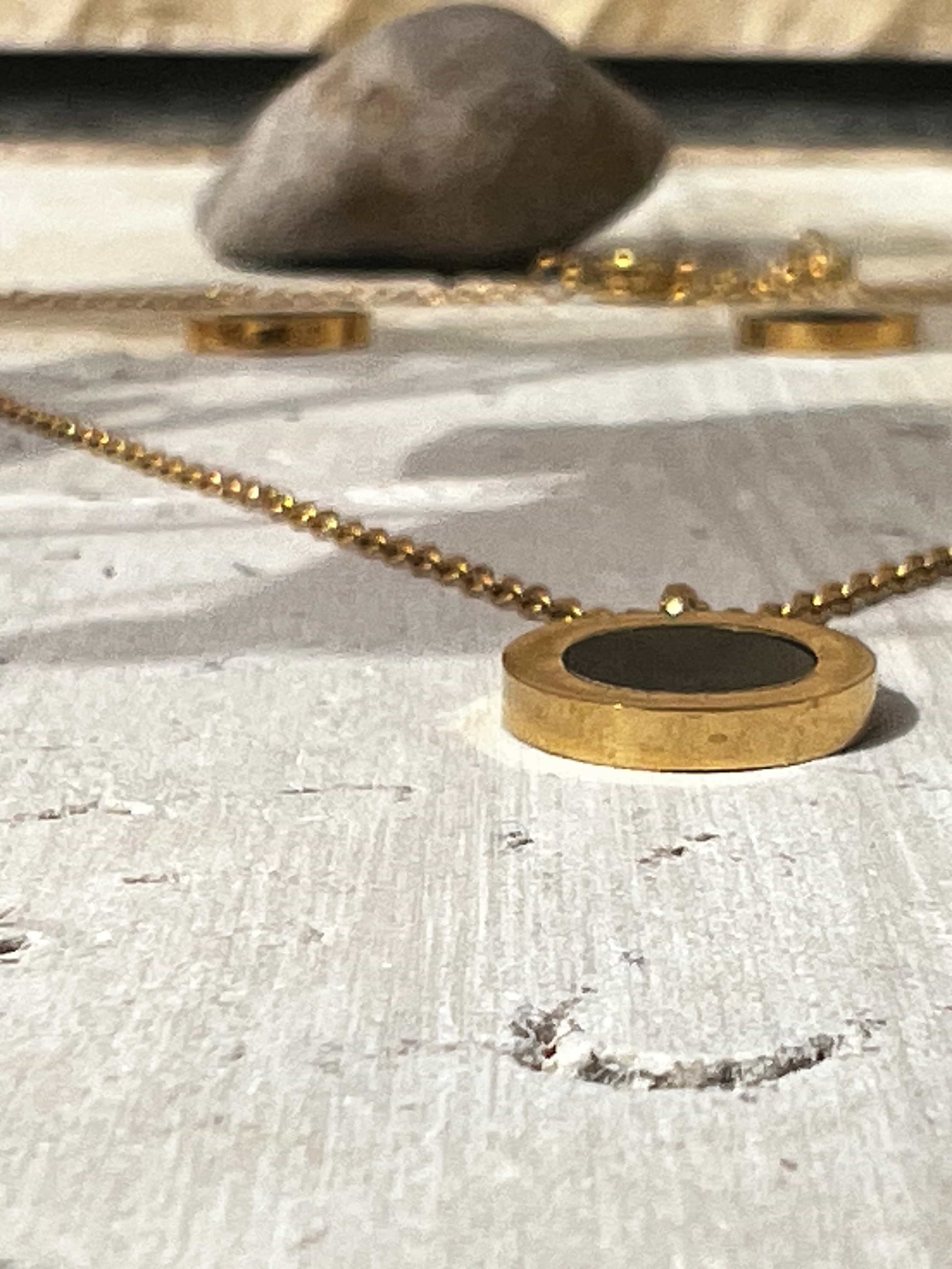 Elegant jewelry for everyday wear featuring a minimalist gold and black necklace with a black enamel pendant — modern jewelry set for women’s fashion accessories.