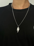 Silver lightning bolt necklace on a black shirt